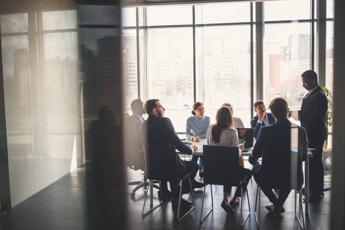 Conference Room Full Of Investors Listening To An M&A Advisor Speak
