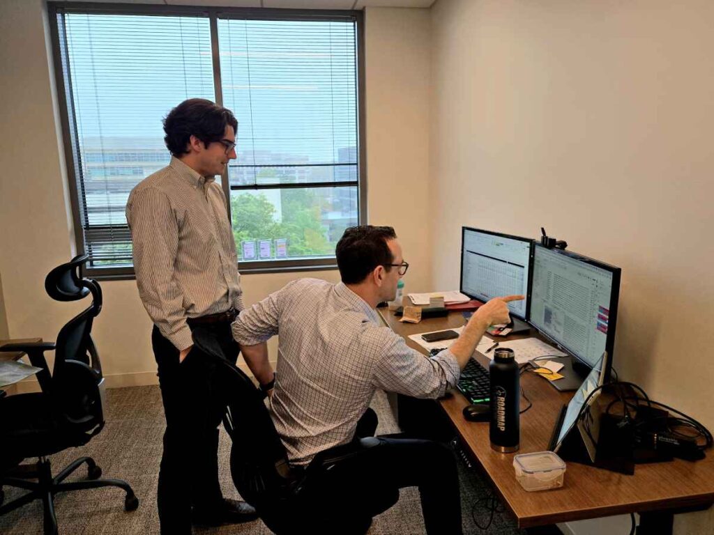 Two M&A Advisors At Roadmap Advisors Reviewing Data