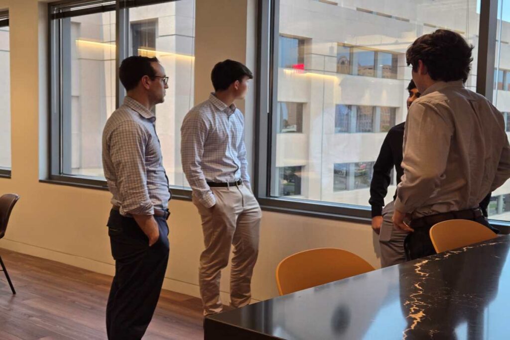 M&A Advisors in a Discussion Near Office Window