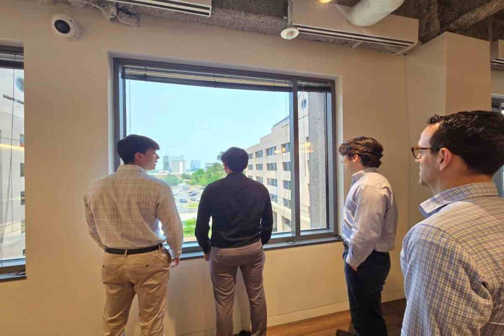M&A Advisors Watching Something Out from Office Window