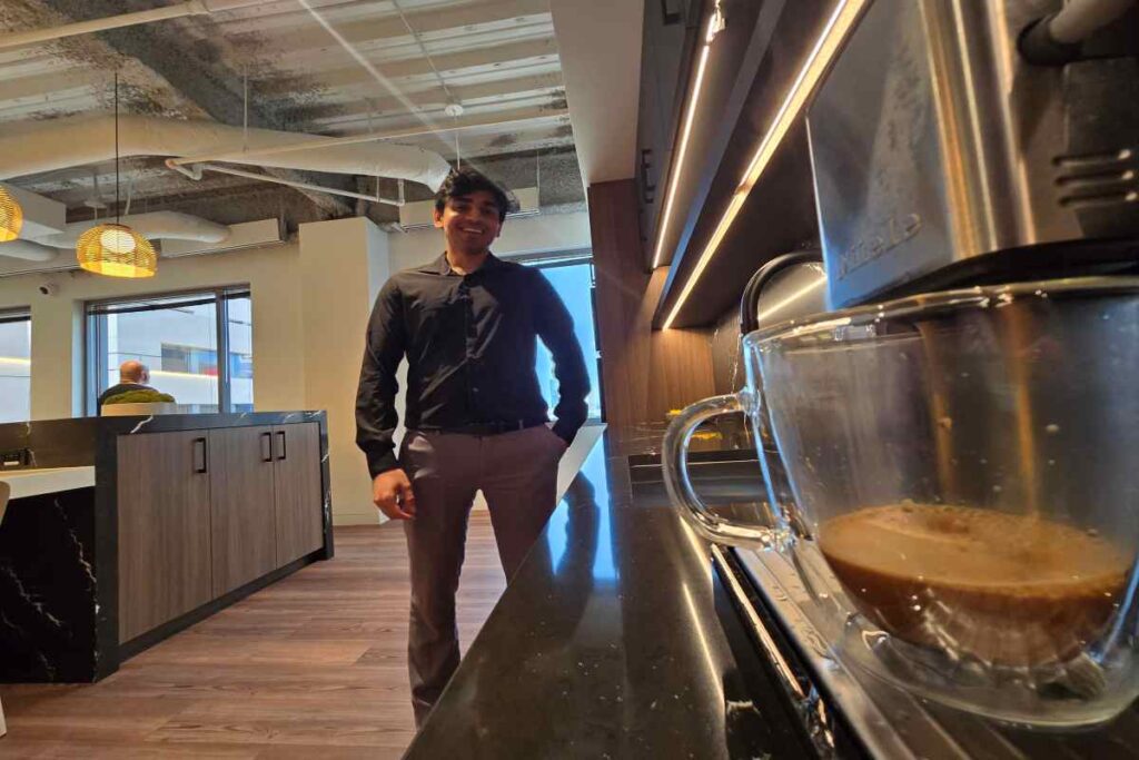 Smiling M&A Advisor Watching Cup Pouring with Coffee