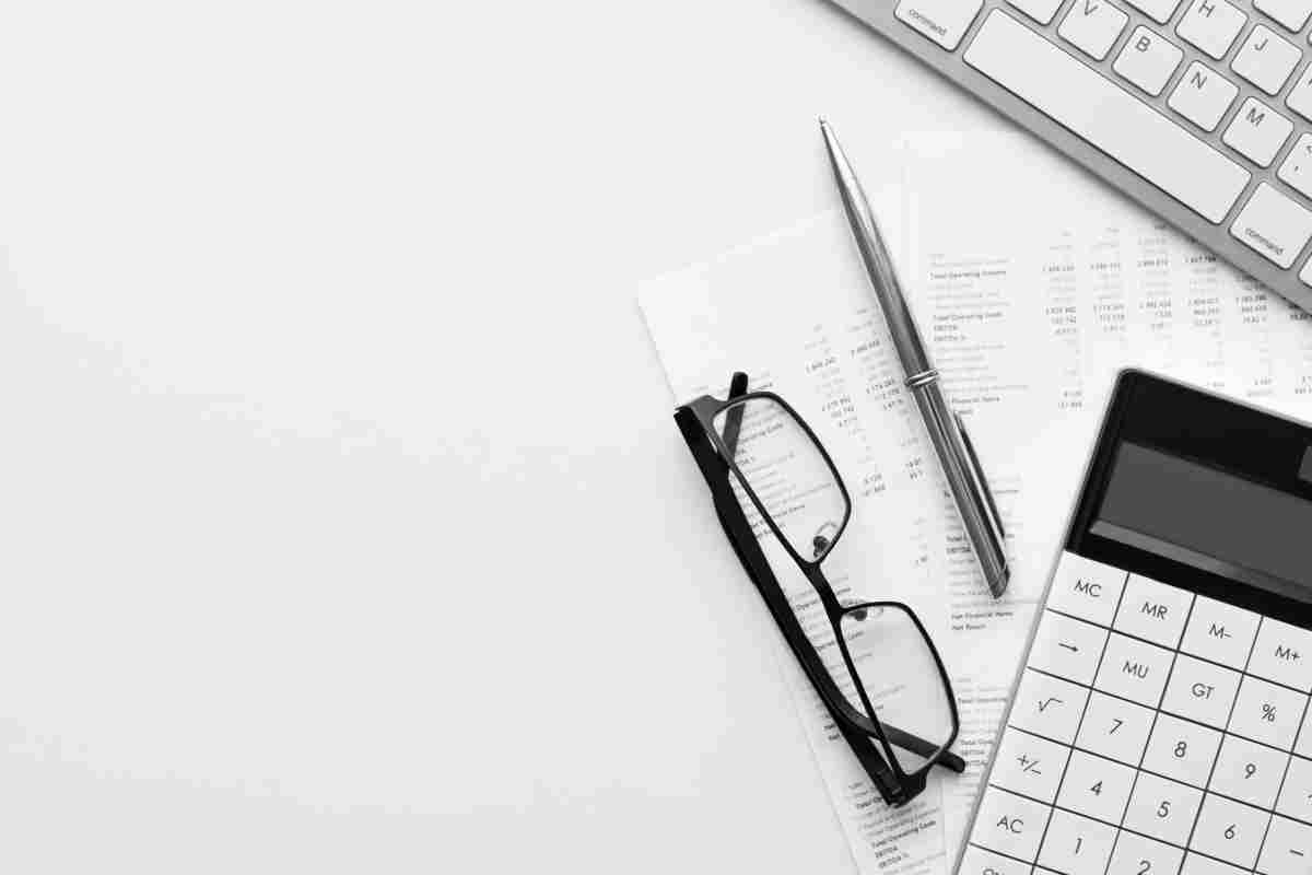 Calculator on financial statement and balance sheeet on desk of auditor. Concept of accounting and audit business.