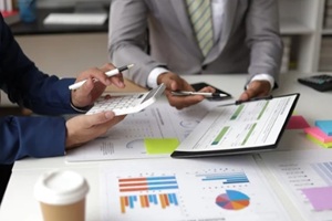 businessman meeting with financial advisors discussing budget planning and analyzing company financial reports