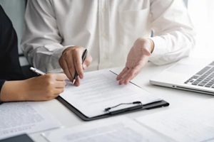 real estate agent broker and customer with loan or insurance contract documents