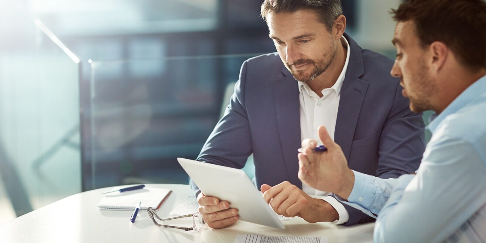 tablet, teamwork and business people talking in office workplace