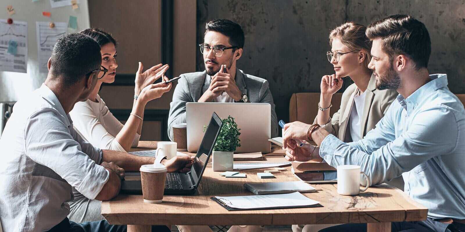 group of young people discussing business while having meeting in the office
