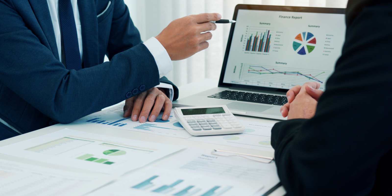 Business Buyers Reviewing Graph Reports of A Paving Company