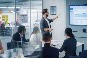 motivated businessman leads business meeting with managers