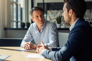 Roofing Business Owner Discussing Selling Strategy with An M&A Advisor