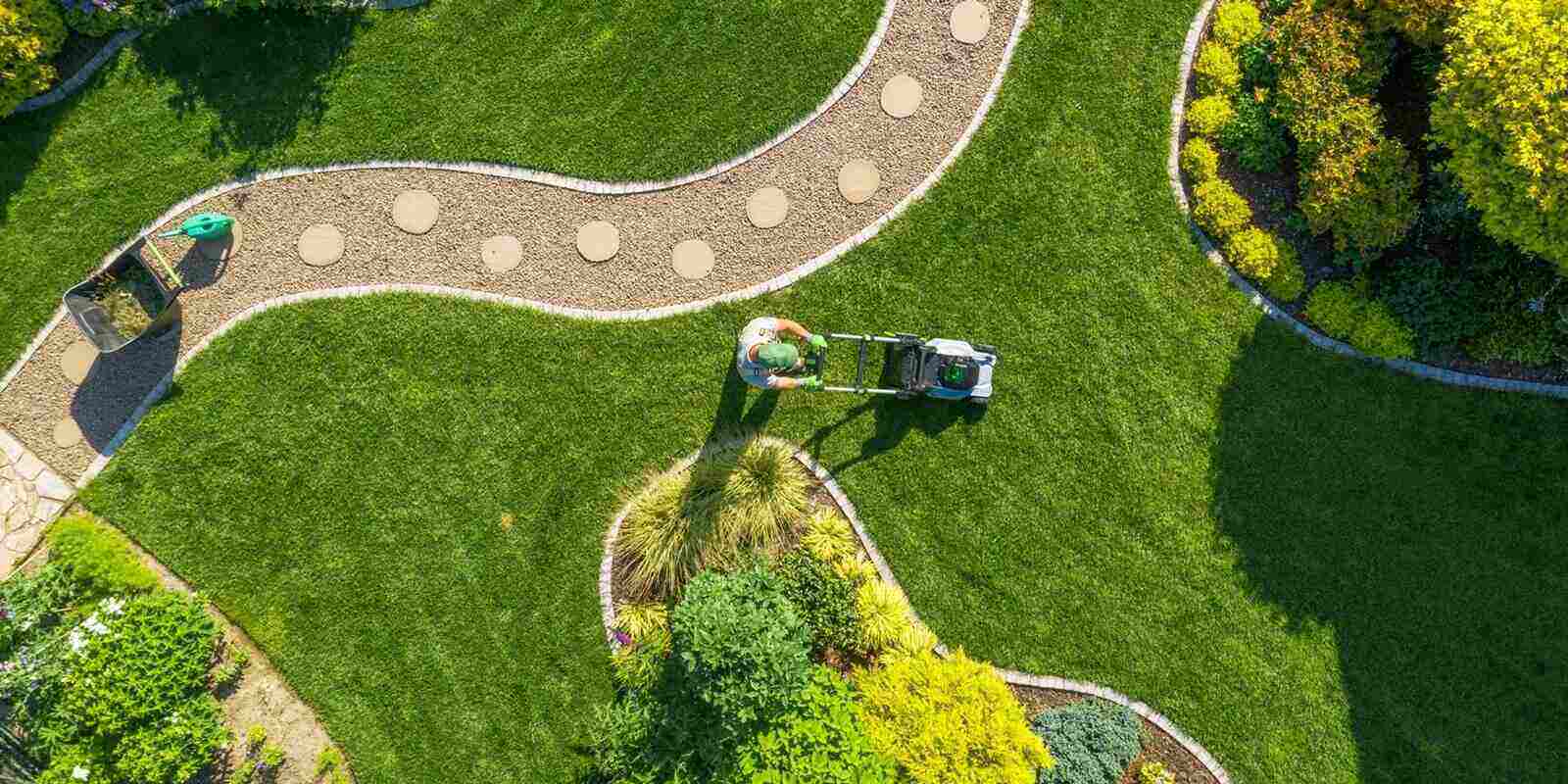 big garden grass field mowing by caucasian gardener