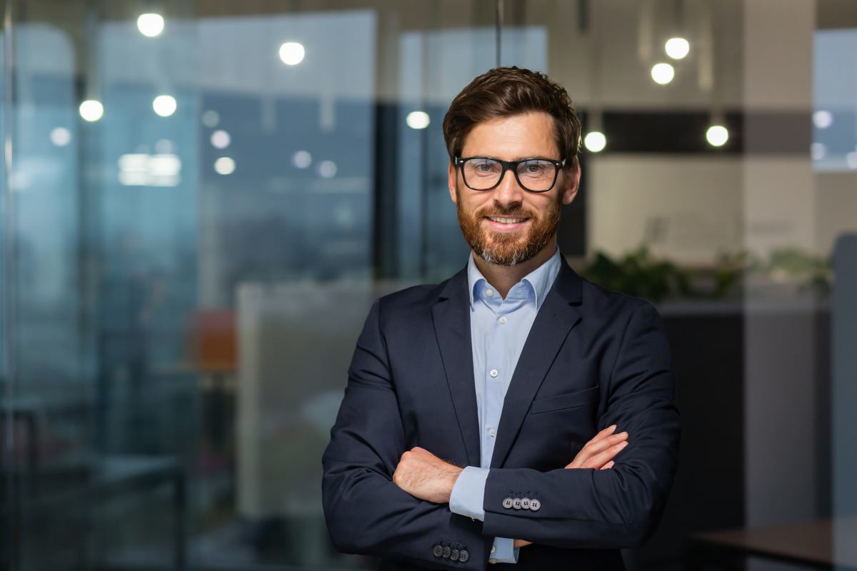 Smiling Business Advisor Standing in His Office