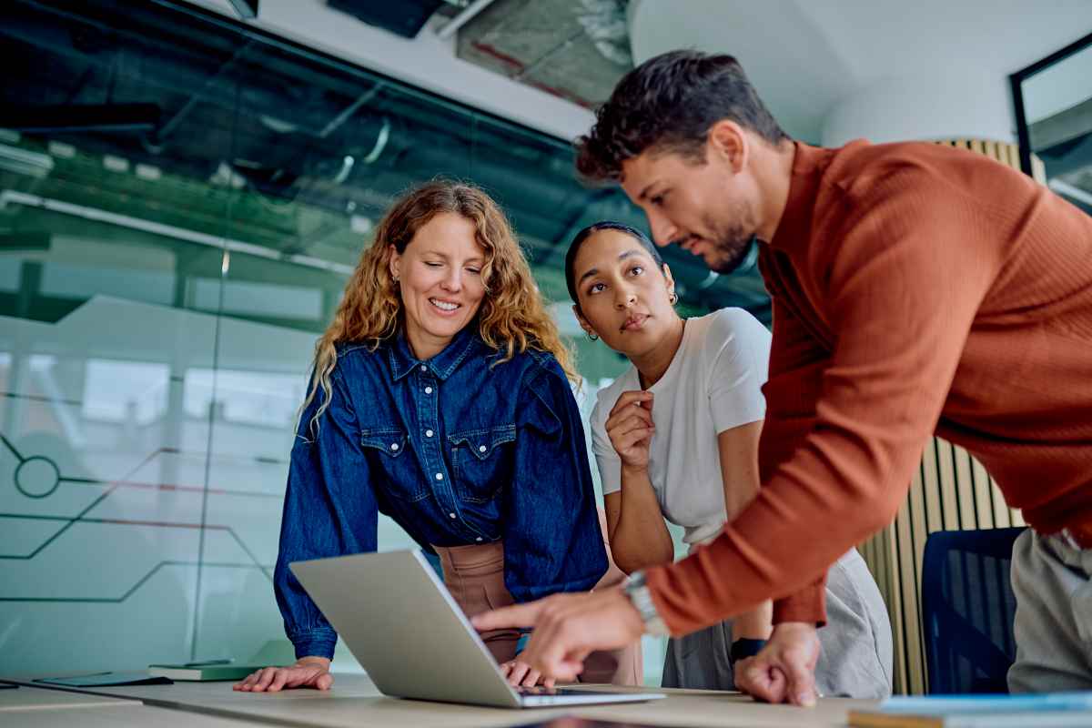 Three Business People Working on Exit Readiness on Laptop