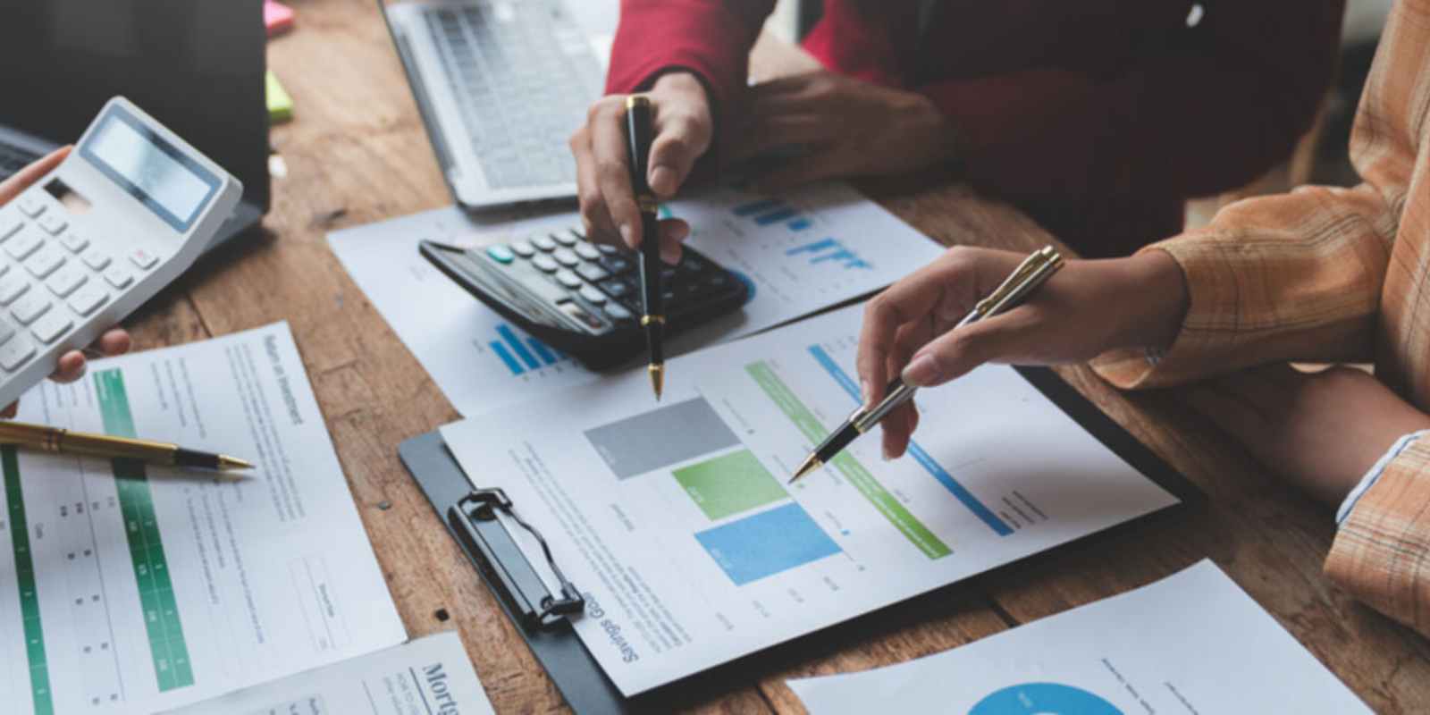 Business Team Analyzing Financial Data with Calculator for Valuation