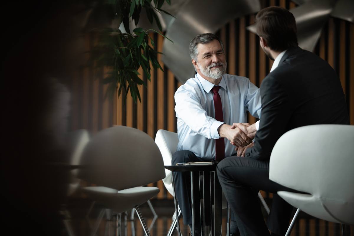M & A Advisor Shaking Hand with Businessman in A Meeting