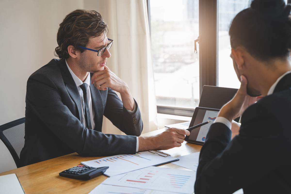 M & A Advisor Showing Business Valuation Plan to Owner