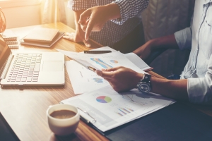 Sell-Side Advisor Helping Businessman Understand Quality of Earning Report