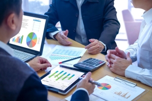 Business Sellers Reviewing Earning Charts Before Buyer