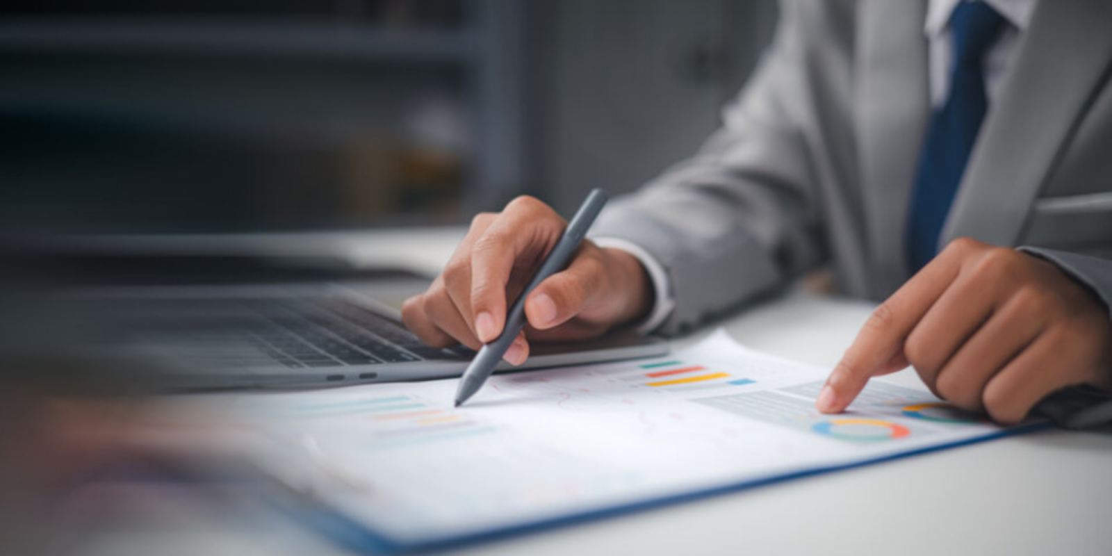 Businessman Reviewing Earning Data Graphs of Business
