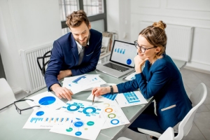 Two Professionals Analyzing Financial Data for Business Valuation