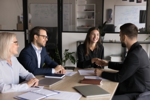 Business Buyer Shaking Hand with Owner in a Conference Room