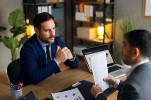 Businessman Evaluating Capability of M&A Advisor in a Meeting
