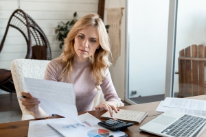 Female Strategic Acquirer Looking Through Paper Documents