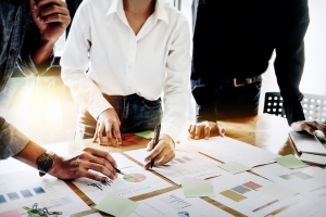 Private Equity Firm Team Reviewing Revenue Quality and Customer Concentration Charts in Office
